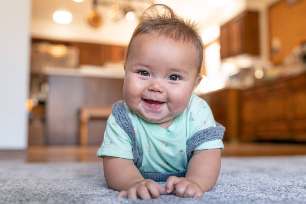Baby lying on carpe flooring | Flooring and More