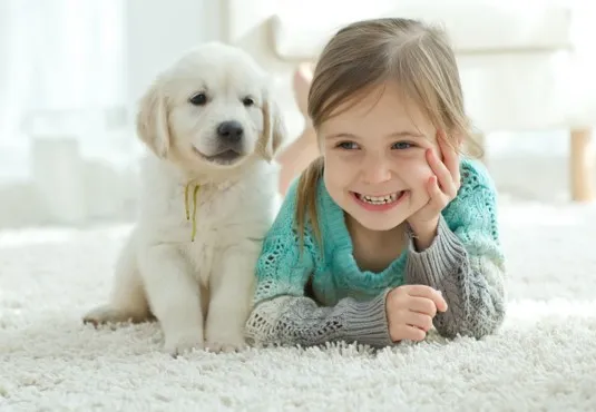 Girl and Dog Laying on Carpet Flooring | Flooring And More